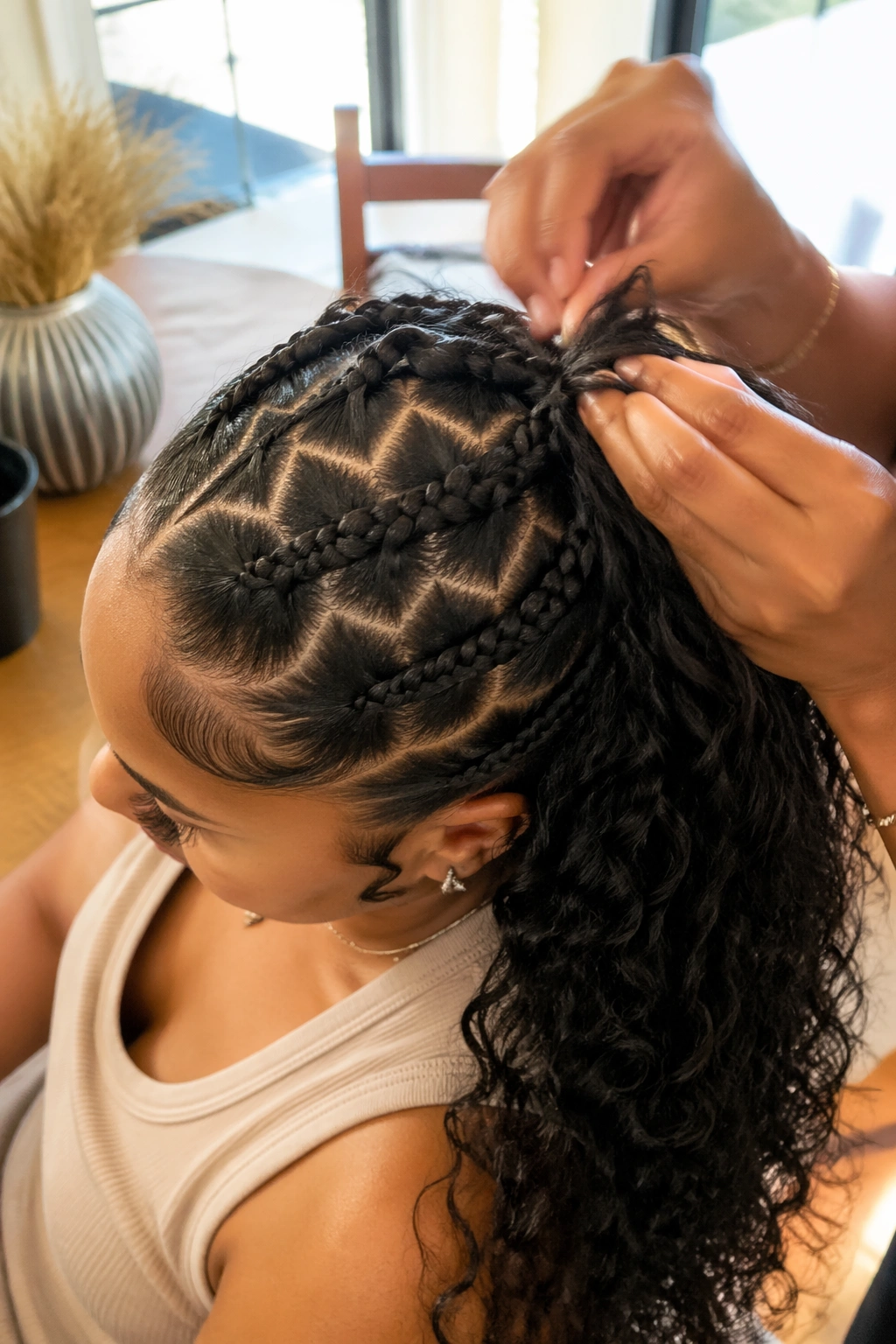 In-use candid of zigzag-part stitch braid ponytail being adjusted.