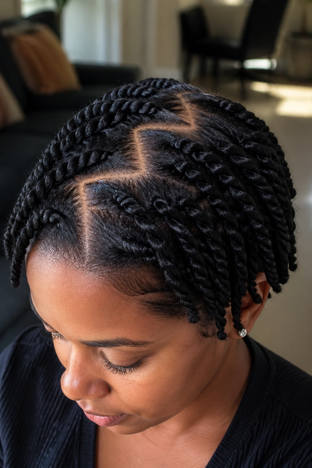 Close-up of a real person showing zigzag part twists on short afro.