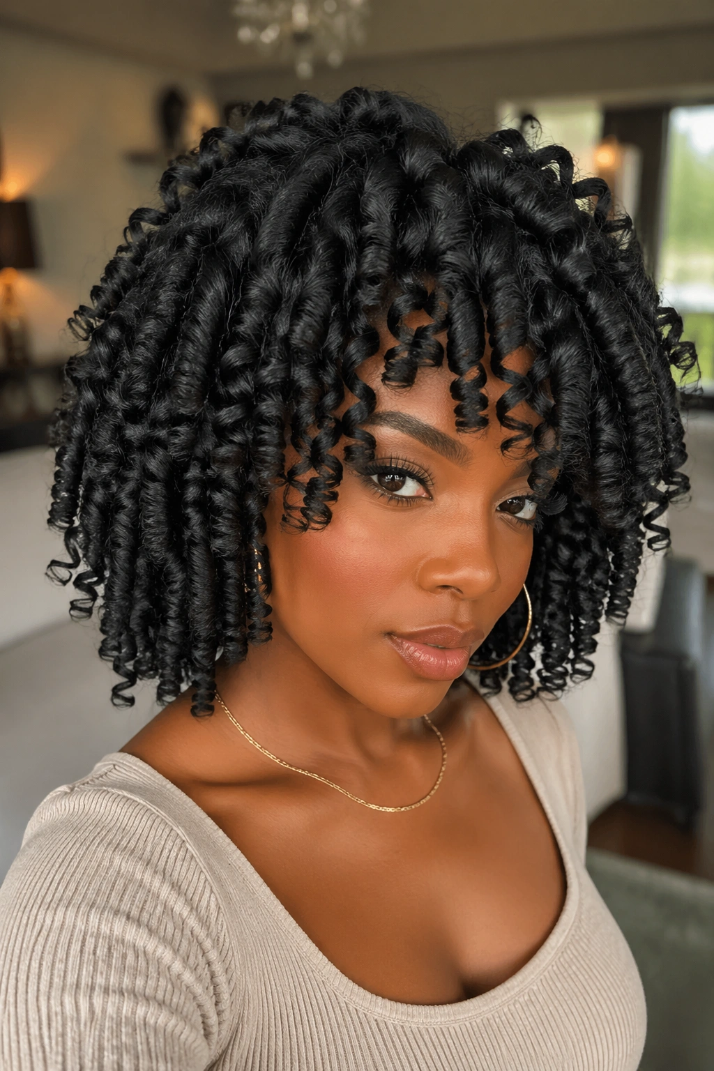 Close-up of a real woman with dramatic bantu knot-out spiral curls