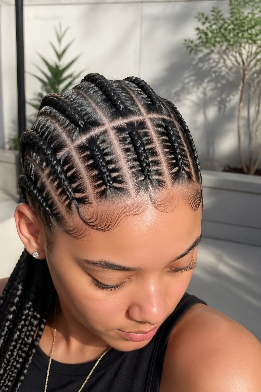 Portrait of a real person with ten box-pattern cornrows