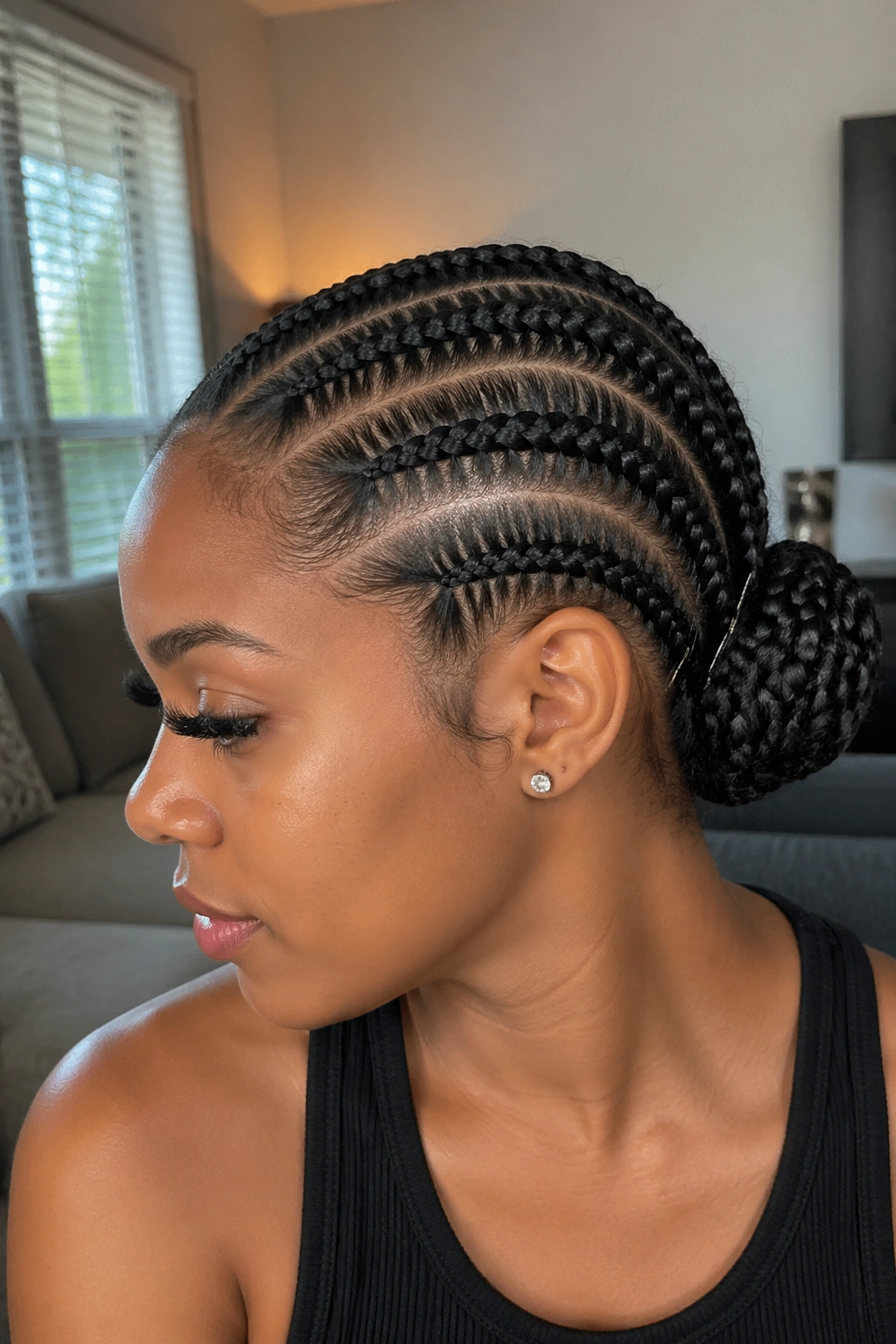 Real woman with five straight backs coiled into a bun at the back of the head