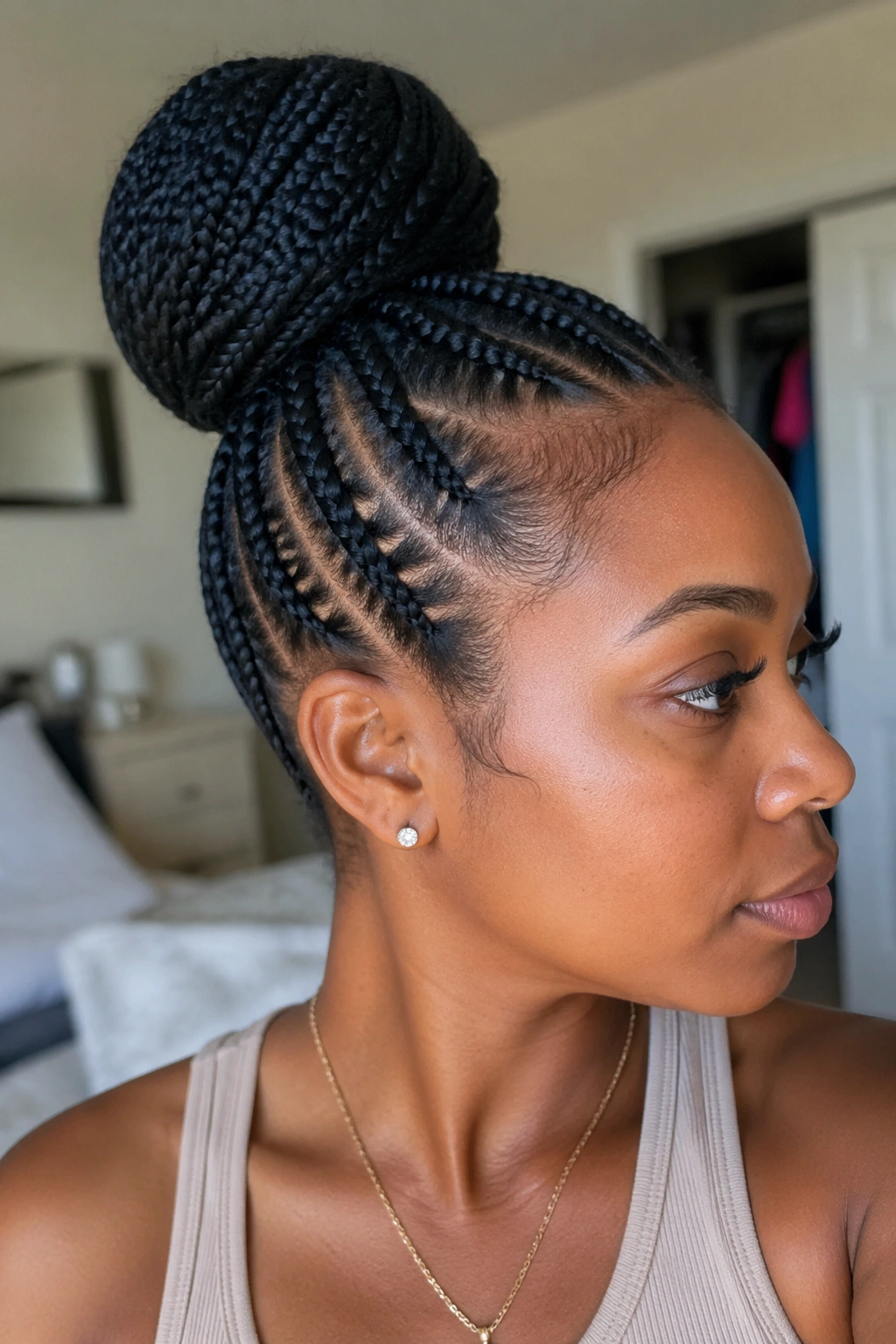 Portrait of a person with a secure cornrow bun showing hold