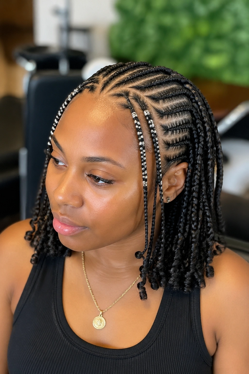 Close-up of cornrows with beaded front sections on a real person, beads visible at the front.