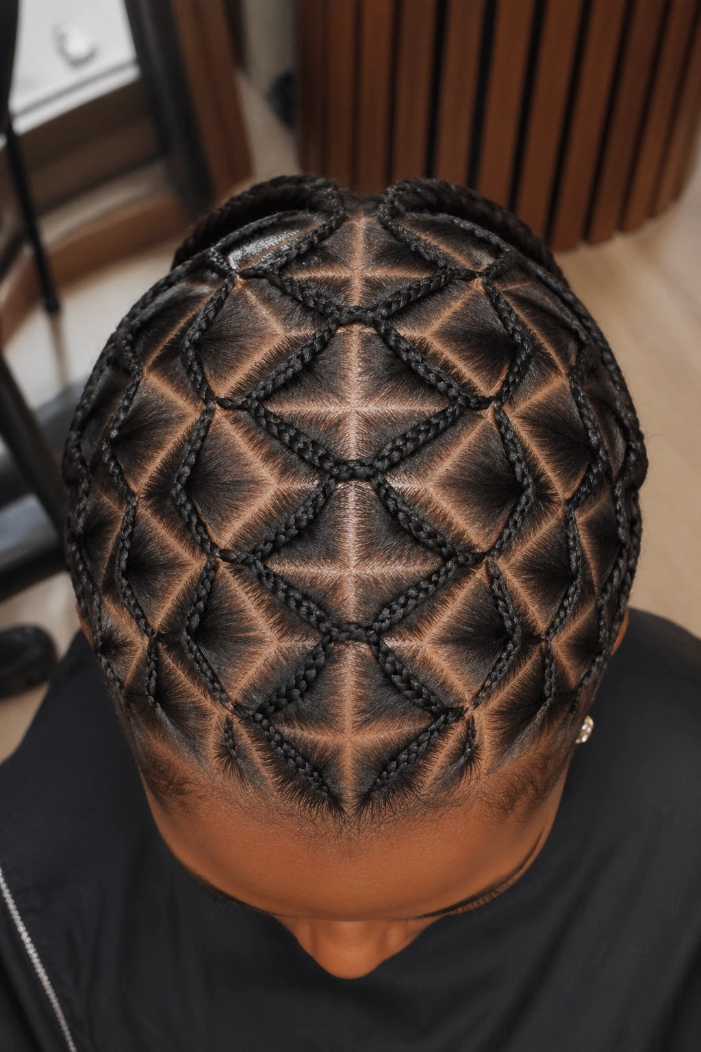 Top-down close-up of diamond-pattern cornrows on a real person