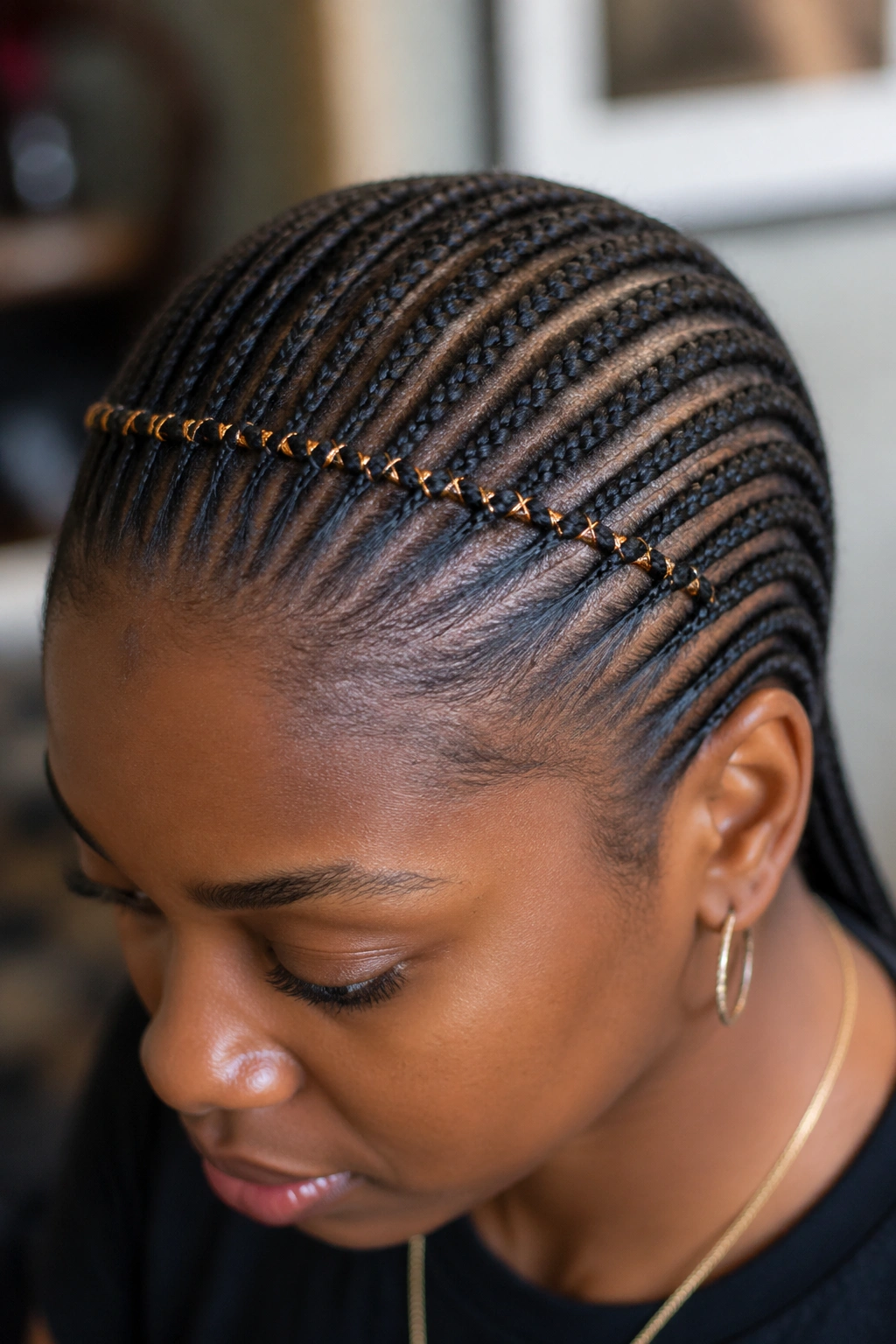 Close-up of cornrows featuring a decorative thread woven through