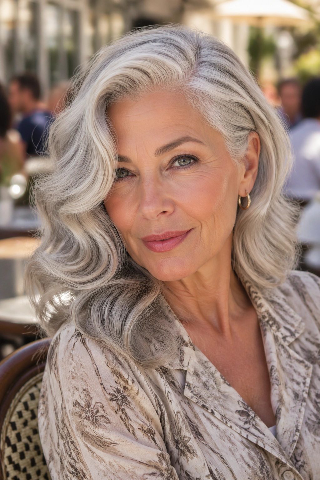 Close-up of a real woman with deep side-part glam waves at a chic brunch setting