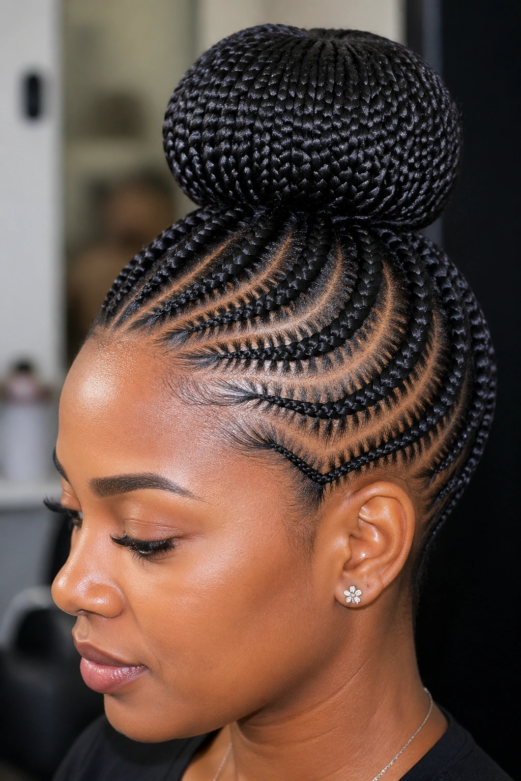 Close-up of a woman with a perfectly round doughnut bun wrapped in kanekalon