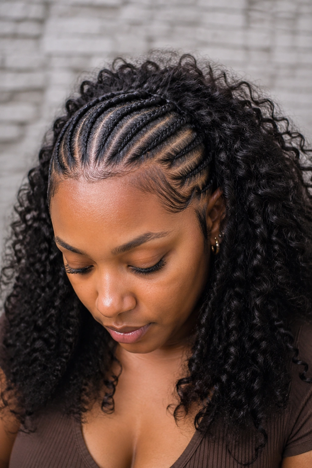 Close-up of real person with kinky curly back weave blending with front cornrows