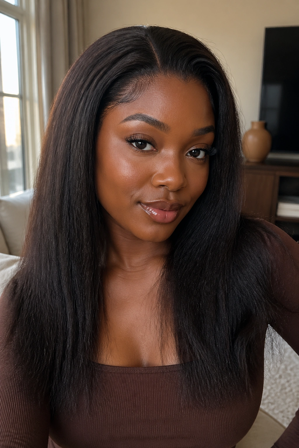 Close-up portrait of a real woman wearing The Kinky Straight Wig with natural hairline