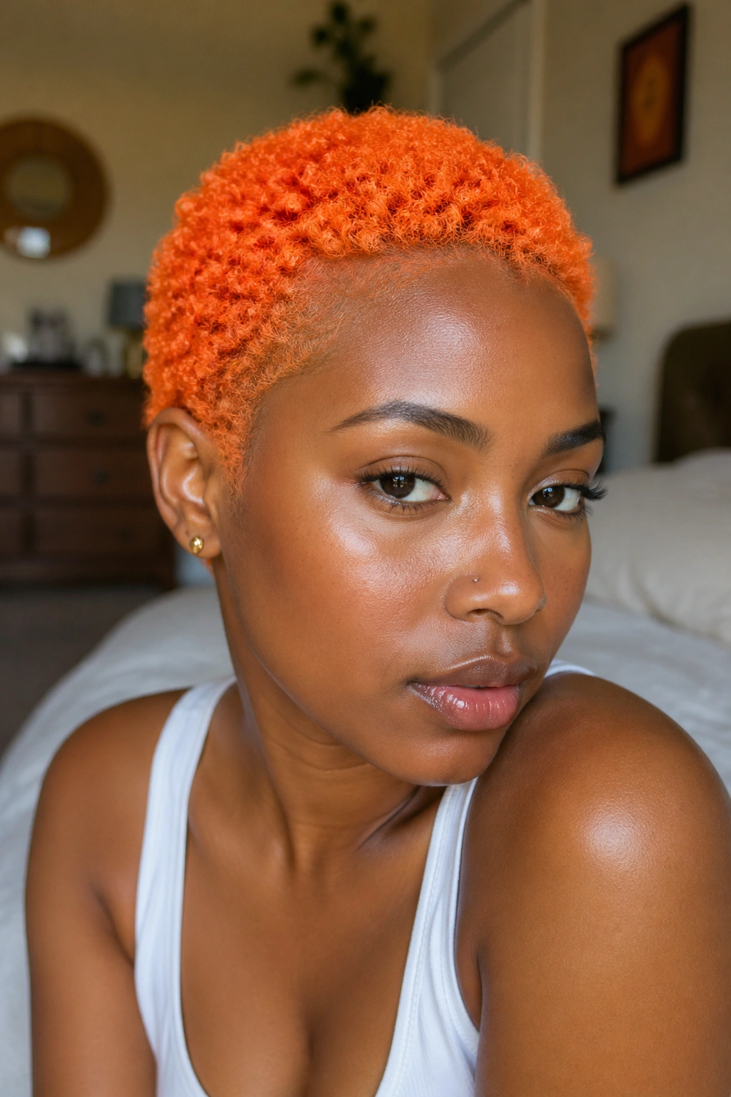 Bright orange TWA on a real person, close-up portrait with bold color