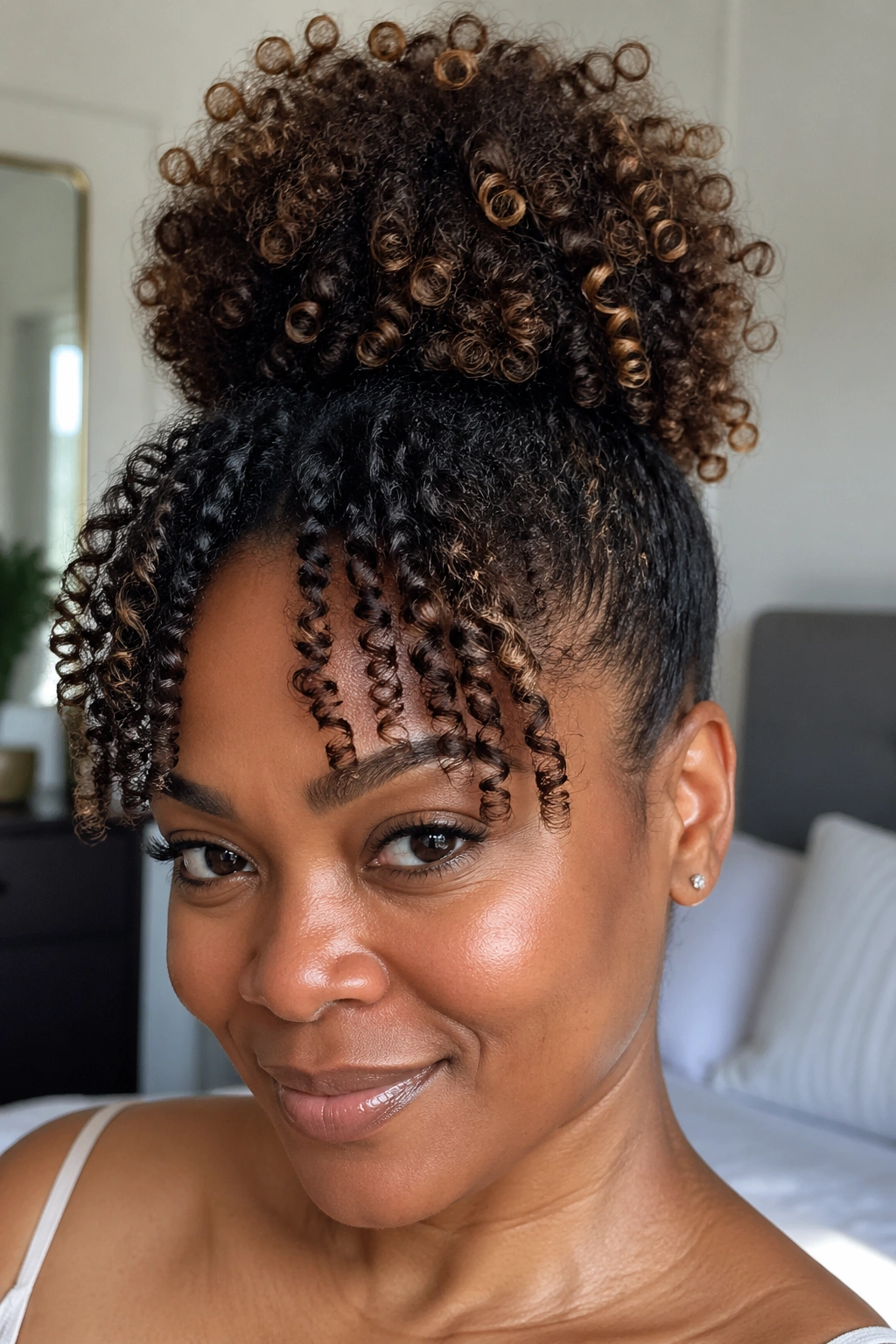 Close-up of a pineapple bun with coily front fringe on a real woman