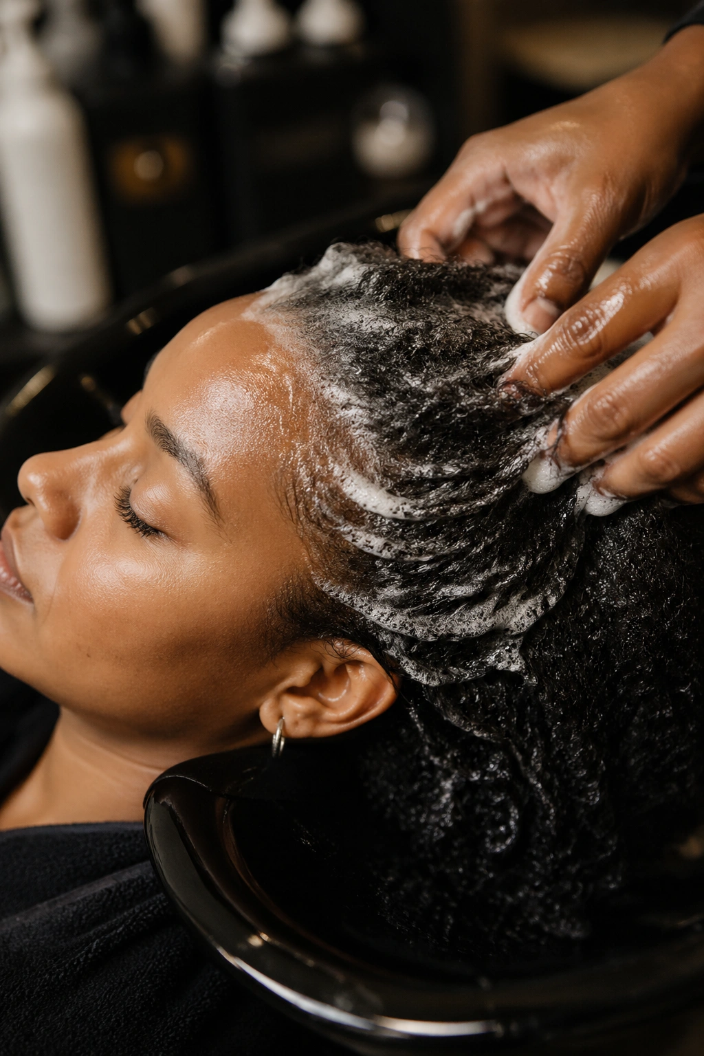 Close-up of a person in salon prep with damp hair ready for braiding