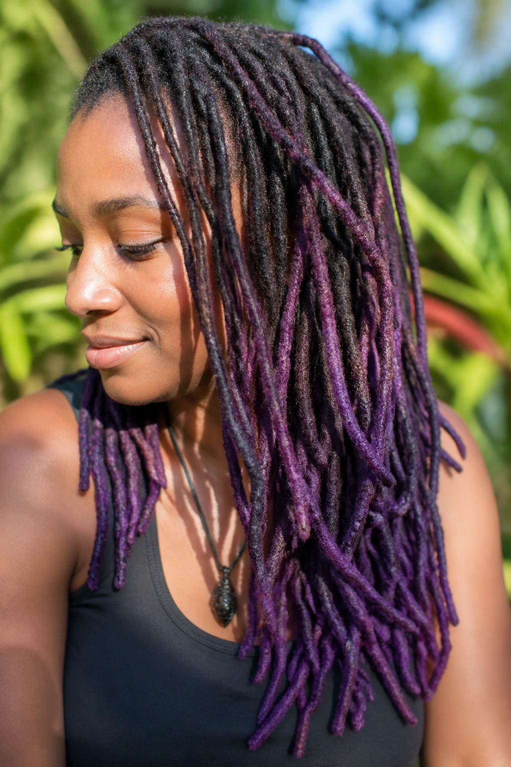 Close-up of a person with purple balayage on locs