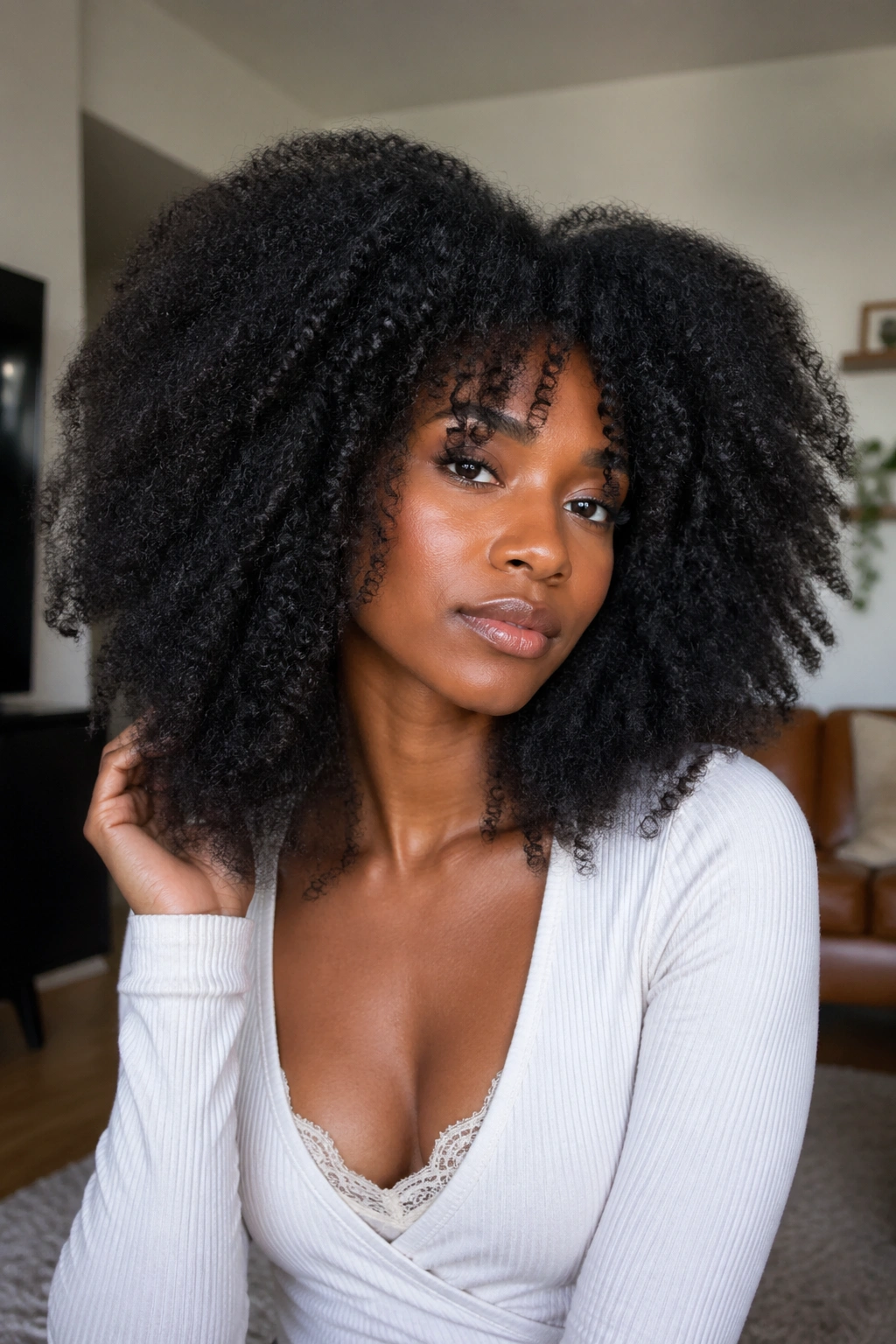 Close-up of a real woman with stretched curly Afro showing length and volume