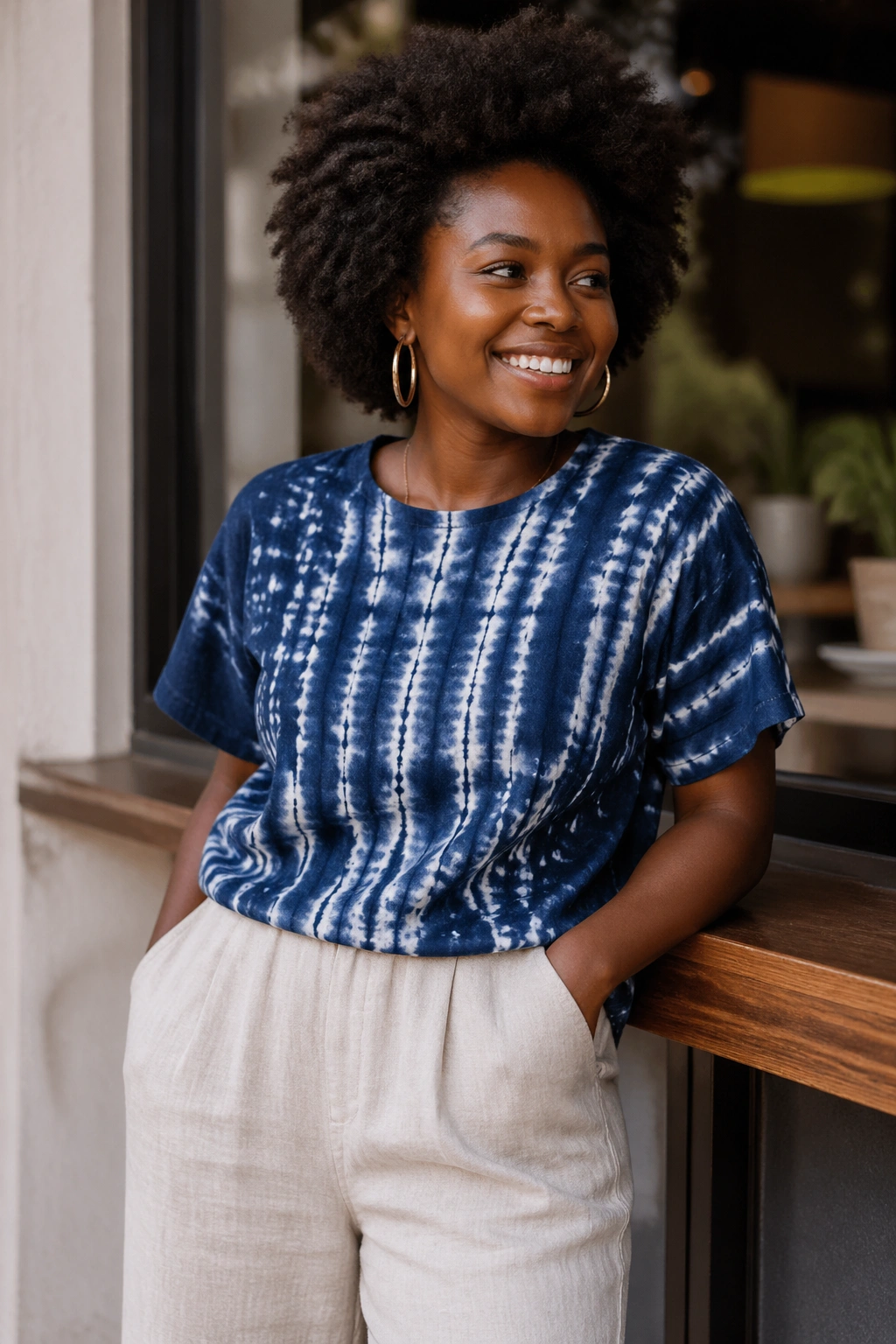 Person wearing indigo tie-dye tee and linen pants outdoors