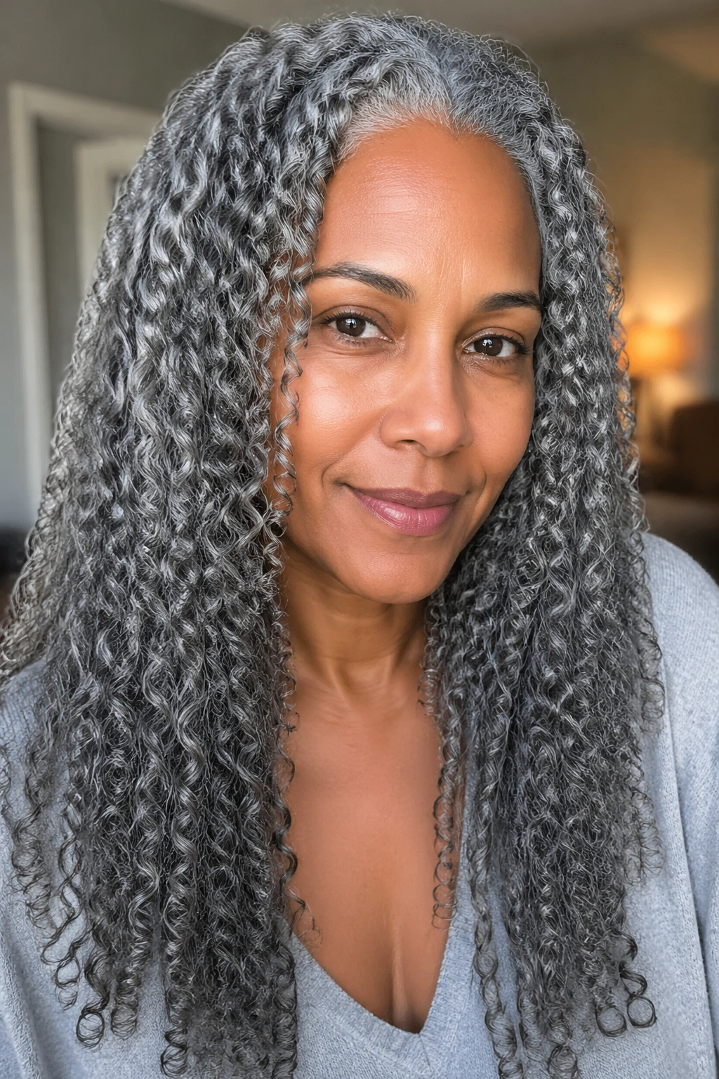 Close-up of a real woman with defined long grey curls after washing